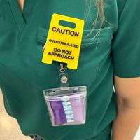 Caution Overstimulated badge reel - Yellow Sign with Black Text, Warning Message for Safety Awareness