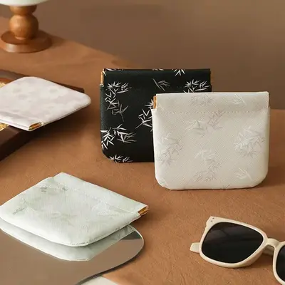 A modern-style snap pouch for storing lipstick, keys, makeup, coins, or charging cables.