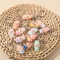 A Set of 6 Stylish And Unique Resin Keychains in Random Mixed Colors, Featuring Transparent Glow-In-The-Dark Rabbits, Perfect...