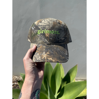 Girlmoss unstructured on camo dad hat with lime green thread.
