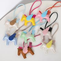 Versatile and fashionable bag charm in the shape of a little horse, in classic color schemes.