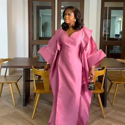 Akwaugo dress made with high quality mikado fabric embellished with crystals design on the neck with a bold love shape sleeve...